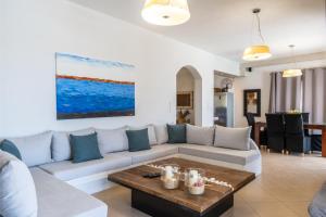a living room with a couch and a table at Revery Villa & House in Ios Chora