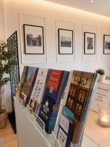 a pile of books sitting on a shelf at Mariclà Boutique Rooms with Balcony & Free Parking in Verona +27 photos