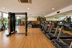 a gym with rows of treadmills and machines at Quality Hotel & Suites Brasília in Brasília