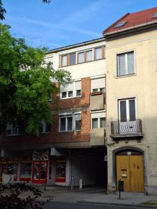 an apartment building with a door and a balcony at Centrum apartman in Szekszárd