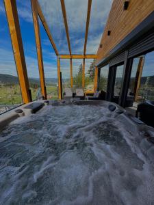 a jacuzzi tub in a house with snow at Vlasic Odmor - Villa Biser & spa in Vlasic
