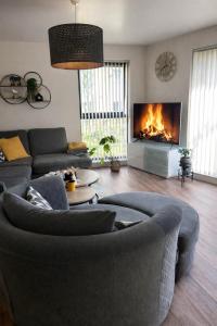 a living room with a couch and a fireplace at Elegant 2-Bed 2-Bath Flat in Edinburgh in Edinburgh