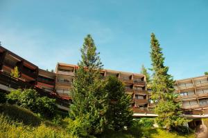 two trees in front of an apartment building at Peaceful Oasis Black Forest in Schonach