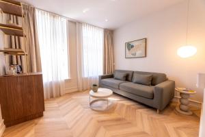 a living room with a couch and a table at EL HOTEL - The Hague in The Hague