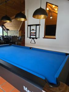 a pool table in a living room with pendant lights at GreenHell Stays Müsch - Nürburgring in Müsch