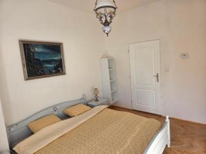a bedroom with a bed and a picture on the wall at White Haven Private Sauna & Pool in Chřibská +16 photos