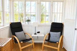 two chairs and a table in a room with windows at Hotel Carl XII in Ed +38 photos