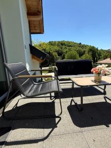 a chair and a table on a patio at Völgyzugoly Apartman in Kőszeg