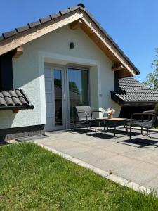 a patio with chairs and a table in front of a house at Völgyzugoly Apartman in Kőszeg