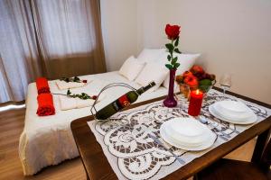 a table with two plates and a bottle of wine at Apartament Polonijna in Krakow