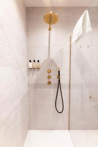 a bathroom with a shower with a glass door at EL HOTEL - The Hague in The Hague