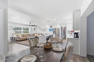 a dining room and living room with a table and chairs at Spacious 4 bedroom 3 bath Clearwater Vacation House Cowboy Pool Fire Pit Games Close to Clearwater Beach Biking Trail Farmers Markets Harbor Health Spa Baycare Ballpark and Ruth Eckerd Hall Golf Courses in Clearwater
