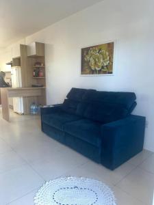 a blue couch sitting in a living room at Germinada in Imbé