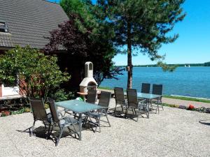 a table and chairs sitting next to a body of water at Schleiblick App 4 in Rabenkirchen-Faulück