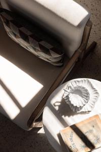 a close up of a toilet and a plate on a table at Maison Le Poete in Vallauris