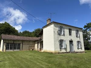 an old white house with a grass yard at Pion La Grange - cottage barn conversion in Castelnau-dʼAuzan