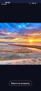 a picture of a sunset at the beach at La Barca in Rye