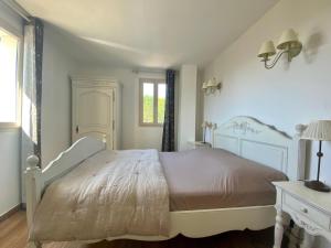 a bedroom with a large bed and a window at La Bastide in Saint-Saturnin-lès-Apt