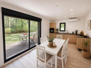 a kitchen and dining room with a table and chairs at Les cabanes in Noaillan +2 photos