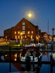 a boat docked in a marina in front of a building at meerBLICK in Orth +7 photos