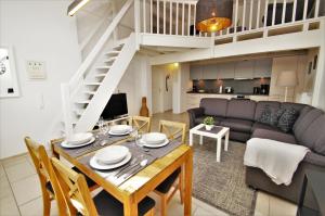 a living room with a dining room table and a couch at Nixe in Dahme +12 photos