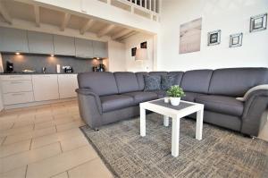 a living room with a couch and a table at Nixe in Dahme