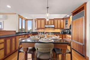 a kitchen with a table and chairs in it at Waterfront Escape Game Room Dog Friendly in Chatham +44 photos