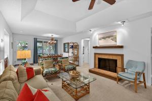 a living room with a couch and a fireplace at IC106: 106 Inlet Cove in Kiawah Island