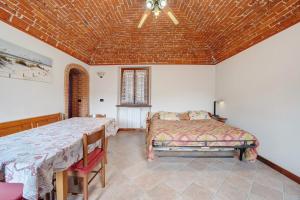 a bedroom with two beds and a ceiling at Centenario Affittacamere in Fara Novarese