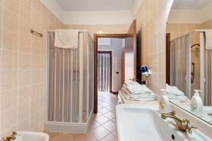 a bathroom with a tub and a sink and a shower at Centenario Affittacamere in Fara Novarese +19 photos