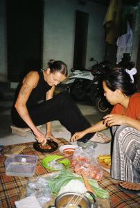 two women sitting on the floor preparing food at Sunset Bungalow Tetebatu in Tetebatu +46 photos