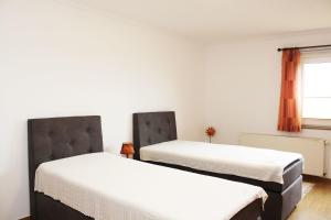 two beds in a room with white walls at Ferienwohnung Klein Süstedt in Klein Süstedt +17 photos