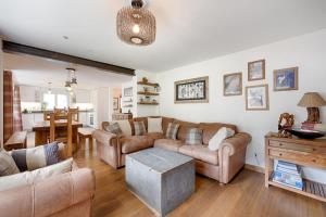 a living room with a couch and a table at Matterhorn Panorama Apartment in Zermatt