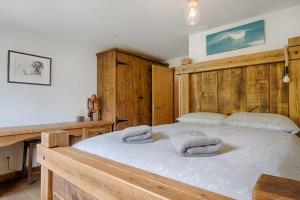 a bedroom with a large bed with towels on it at Matterhorn Panorama Apartment in Zermatt