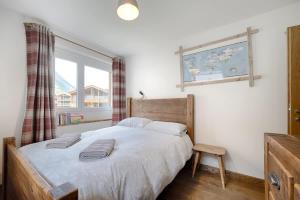 a bedroom with a large bed and a window at Matterhorn Panorama Apartment in Zermatt