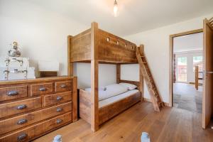 a bedroom with a bunk bed and a dresser at Matterhorn Panorama Apartment in Zermatt