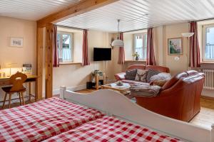 a living room with a bed and a couch at Haus Belchenwind in Münstertal