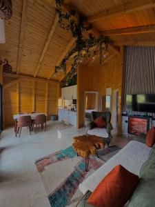 a living room with a couch and a table at Vlasic Odmor - Villa Biser & spa in Vlasic