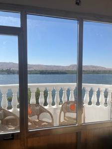 a view of the water from a balcony with vases at Farida Nile view in Luxor
