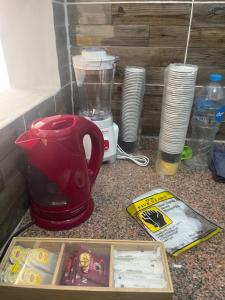 a kitchen counter with a blender and a red tea kettle at Farida Nile view in Luxor