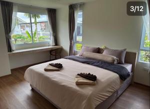 a bedroom with a bed with two towels on it at Modern Apartment with Queen Bed in Living Room & Separate Bedroom in Lamai +13 photos