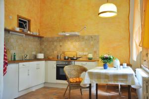 a small kitchen with a table with a tablecloth on it at Villa-Hufeland in Berlin