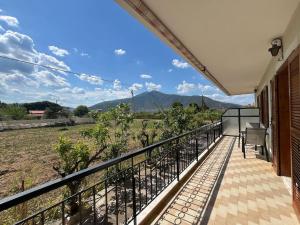 a balcony with a view of a field and mountains at Beautiful apartment with mountain view in Paralio Astros