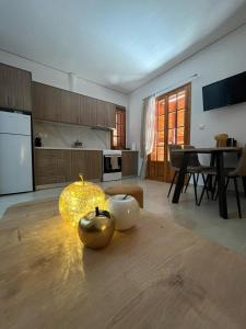 a living room with a table and a kitchen at Beautiful apartment with mountain view in Paralio Astros