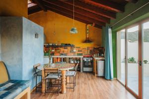 a kitchen with a table and chairs in a room at Vida Pura Apartments in Odeceixe