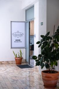 a room with two potted plants and a glass door at A Casa da Luísa in Vila Real