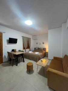 a living room with a bed and a couch at Beautiful apartment with mountain view in Paralio Astros