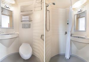 a bathroom with a toilet and a sink and a shower at Fasthotel Angers Beaucouzé in Beaucouzé