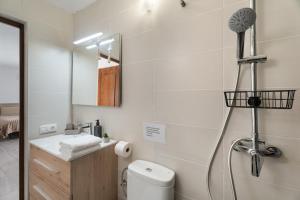 a bathroom with a shower with a toilet and a sink at El Barril in Chio