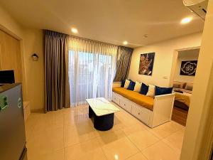 a living room with a couch and a window at Modern Apartment with Queen Bed in Living Room & Separate Bedroom in Lamai